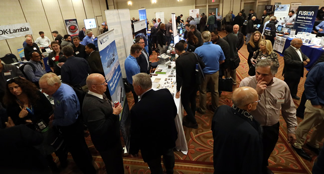 A packed exhibit floor at the 2023 IEEE LI Power Electronics Symposium